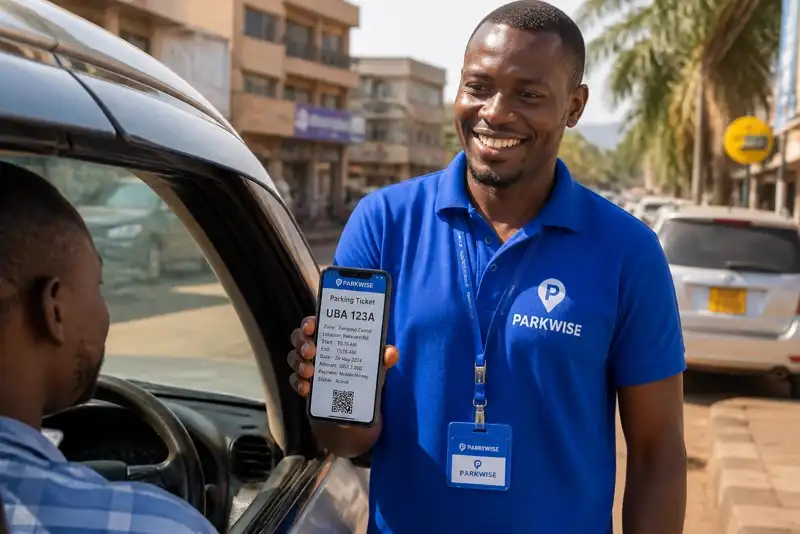 Parkwise attendant in a branded Parkwise T-shirt showing a driver the parking ticket on a phone