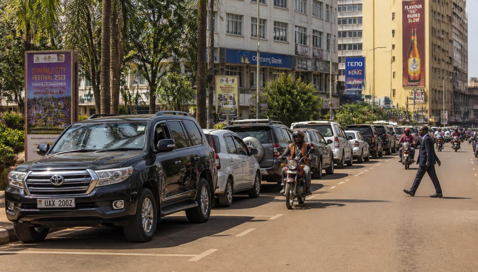 On-street parking along a busy Kampala city street